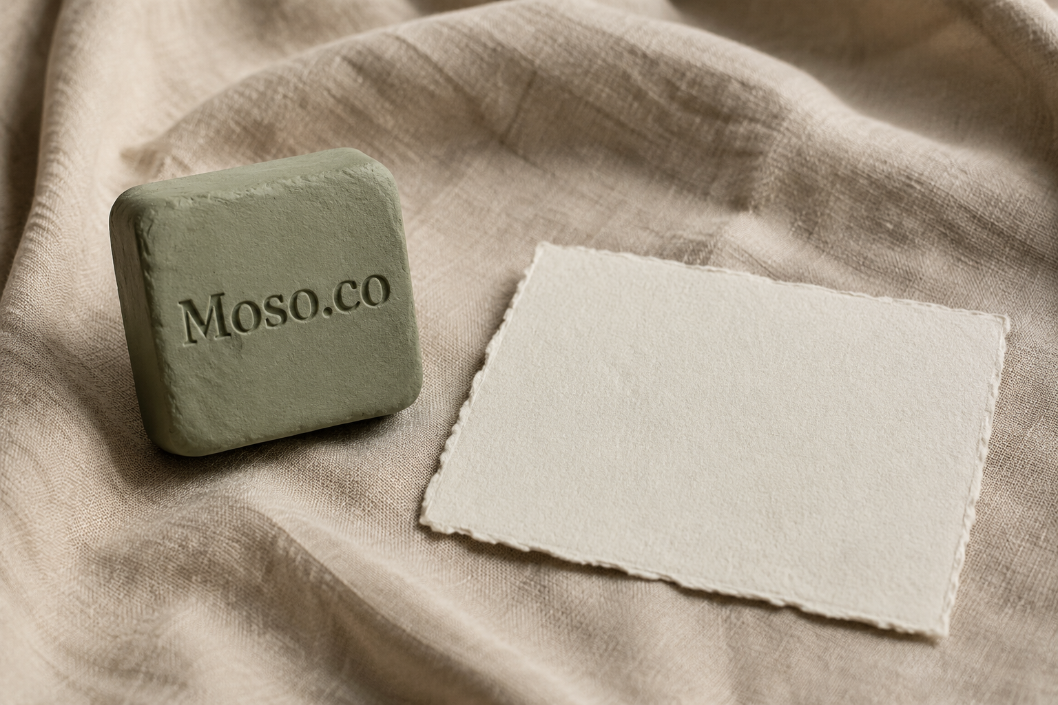 Pale linen card with the Moso.co wordmark beside a graphite stamp